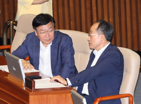 People Power Party (PPP) Rep. Jeong Jeom-sig, left, and PPP floor leader Choo Kyung-ho speak inside the main chamber of the National Assembly on Thursday. [YONHAP]