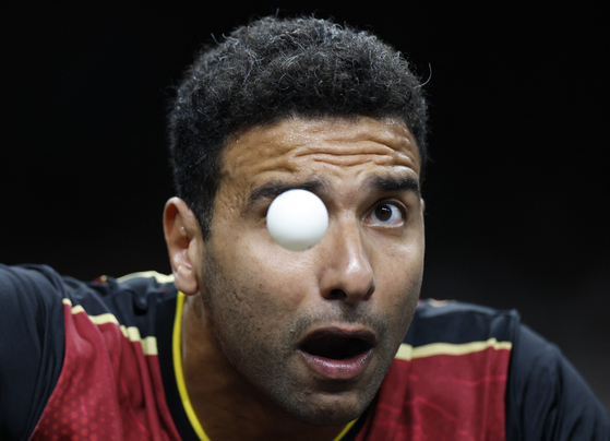 Omar Assar of Egypt in action during his quarterfinal match against Truls Moregard of Sweden in the men's singles table tennis tournament in Paris on Thursday.  [REUTERS/YONHAP]