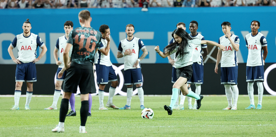 Girl group NewJeans take turns kicking the ball ahead of the match between Bayern Munich and Tottenham Hotspur at Seoul World Cup Stadium in western Seoul on Saturday. [NEWS1]