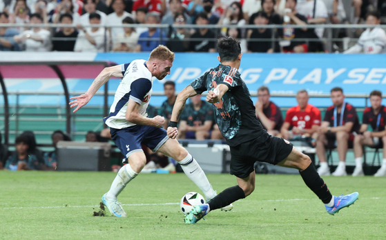 Tottenham Hotspur forward Dejan Kulusevski, left, in action against Bayern Munich defender Kim Min-jae during a Coupang Play Series match at Seoul World Cup Stadium in western Seoul on Saturday. [NEWS1] 