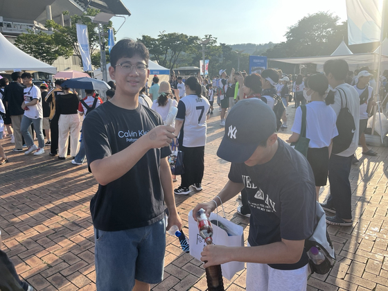 Fans prepare to enter the stadium. [MARY YANG]