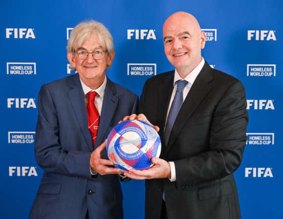 Homeless World Cup Co-Founder and President Mel Young, left, poses with FIFA President Gianni Infantino in Paris on Saturday. [FIFA]