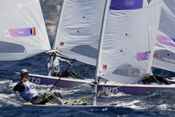 Korean sailor Ha Jee-min, front, participates in a men's dinghy class race during the Paris Olympics on Saturday in Marseille, France. [AP/YONHAP]