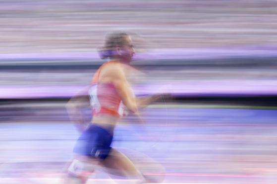 Femke Bol of the Netherlands runs in a women's 400 meters hurdles round 1 heat in Paris on Sunday. [AP/YONHAP]