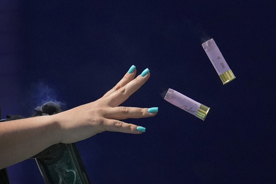 Britain's Amber Jo Rutter ejects empty cartridges from her gun as she competes in the women's skeet final in Chateauroux, France. [AP/YONHAP]