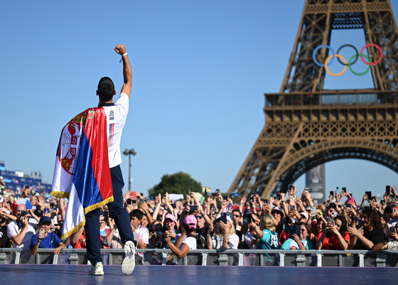 Serbian tennis super star Novak Djokovic, who claimed gold in the tennis men's singles at the Paris Olympics, reacts at the Champions Park in Paris on Monday.  [XINHUA/YONHAP]