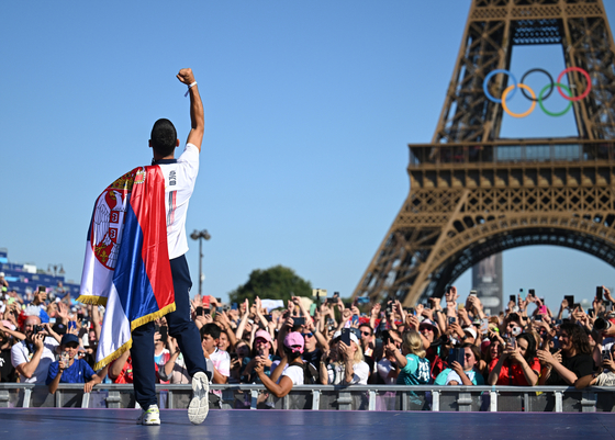 Serbian tennis super star Novak Djokovic, who claimed gold in the tennis men's singles at the Paris Olympics, reacts at the Champions Park in Paris on Monday. [XINHUA/YONHAP]