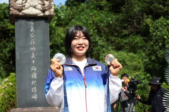 Huh Mi-mi, the judoka who won a silver medal and bronze medal at the Paris Olympics, shows her medals at the memorial altar of her great-grandfather, who was an independence activist during the 1910-1945 Japanese colonial rule, in Gunwi County in Daegu on Tuesday. [YONHAP] 