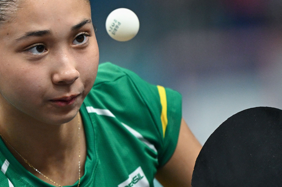 Brazil's Bruna Takahashi eyes the ball during a women's table tennis singles match against Korea in Paris on Monday.  [AFP/YONHAP]