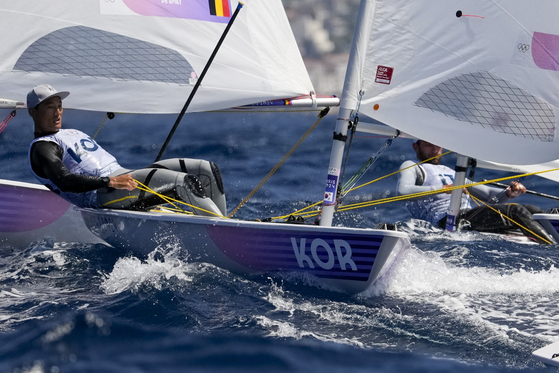 Korea's Ha Jee-min, left, participates in a men's dinghy race during the 2024 Paris Olympics on Saturday in Marseille, France. [AP/YONHAP]