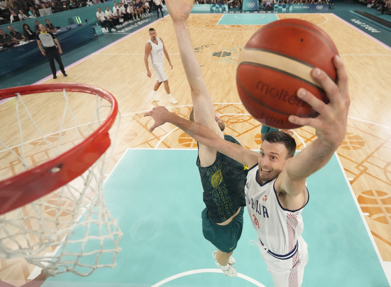 Aleksa Avramovic of Serbia in action against Jock Landale of Australia during the men's basketball quarterfinal of the Paris Olympics in Paris on Tuesday. [REUTERS/YONHAP] 