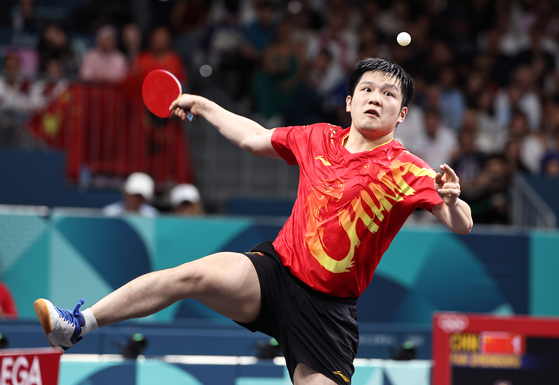 Fan Zhendong of China competes in the men's table tennis team gold medal match in Paris on Friday. [XINHUA/YONHAP]