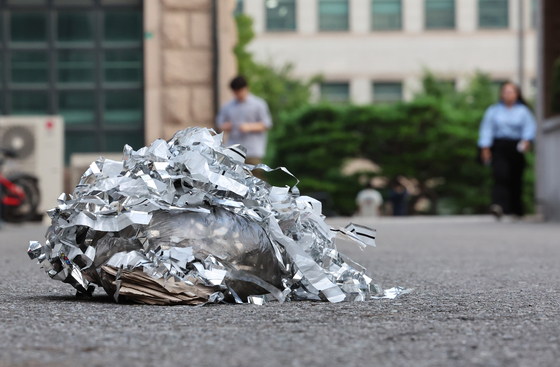 Contents of a trash balloon launched by North Korea are seen on a street on the campus of Yonsei University in Mapo District, western Seoul, on July 24. [YONHAP]