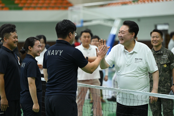 President Yoon Suk Yeol, right, greets Naval officers and Marines during a visit to the Jinhae naval base in Changwon, South Gyeongsang, Wednesday. [PRESIDENTIAL OFFICE]