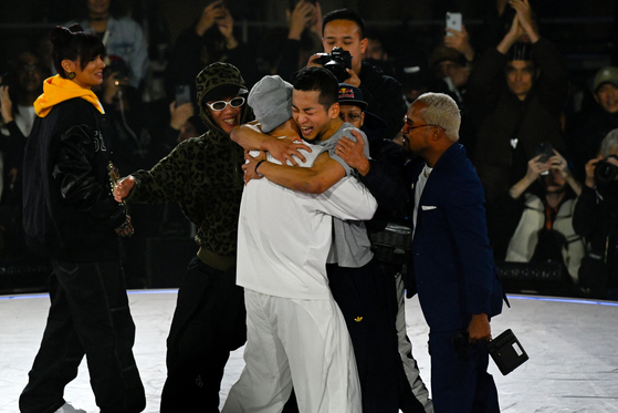 Korea's Hong 10 embraces Canada's Phil Wizard after winning at the B-Boy final at the Red Bull BC One Championship in Paris on Oct. 21, 2023. [AFP/YONHAP]