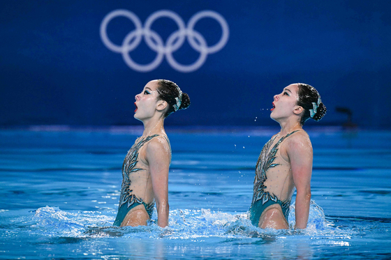 Korea's Hur Yoon-seo and Lee Ri-young compete in the duet free routine of the artistic swimming event during the Paris Olympics at the Aquatics Centre in Saint-Denis on Saturday. [AFP/YONHAP]