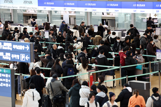 Tourists queue at Incheon International Airport for flights to Japan. [YONHAP]