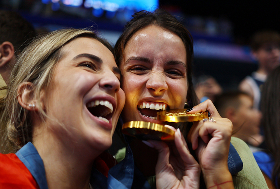 Serbian water polo player Sava Randelovic's girlfriend, right, celebrates Serbia's gold medal in men's water polo at La Defense Arena in Nanterre, France on Sunday. [REUTERS/YONHAP]