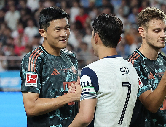 Bayern Munich's Kim Min-jae, left, greets Tottenham Hotspur's Son Heung-min at Seoul World Cup Stadium in western Seoul on Aug. 3. [NEWS1]