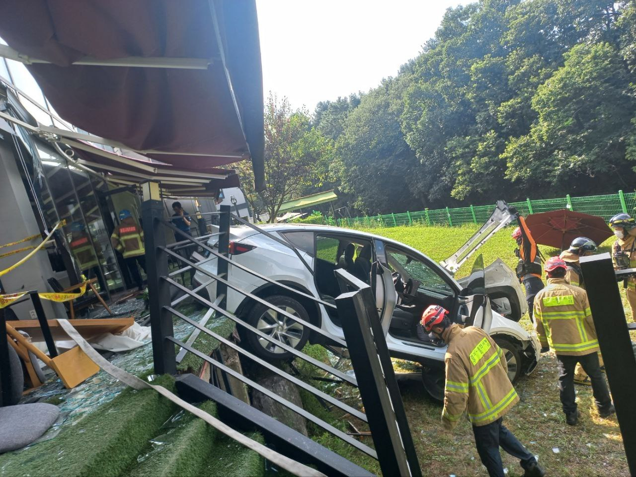 A Tesla driven by a woman in her 60s crashed through a cafe in Yongin, Gyeonggi, injuring 11 people, on Aug. 14. [NEWS1] 