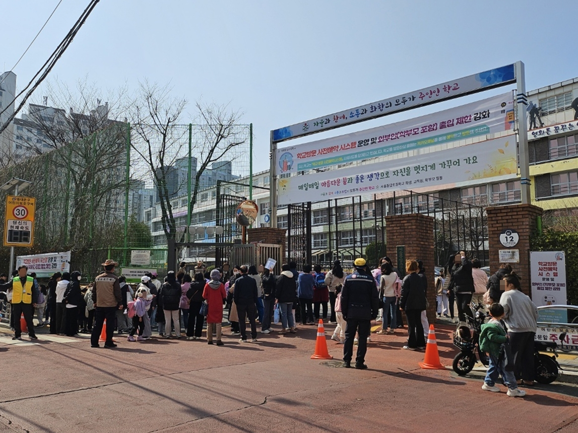 Security guard and faculty prevent parents from entering the Seoul Dongdap Elementary School in Dongdaemun District, eastern Seoul, in March. [SEOUL DONGDAP ELEMENTARY SCHOOL]