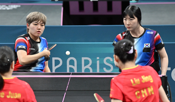 Korean table tennis players Yoon Ji-yu, left, and Seo Su-yeon compete in the women's doubles WD5 final against China at the 2024 Paris Paralympic Games in Paris on Friday. [NEWS1] 