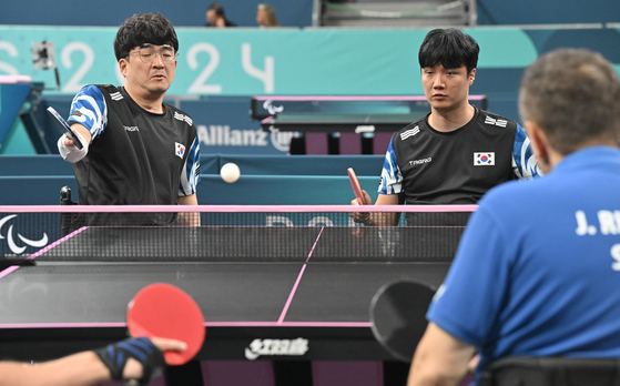 Korean table tennis players Cha Soo-young, left, and Park Jin-cheol compete against Slovakia in the men's doubles semifinals at the 2024 Paris Paralympic Games in Paris on Friday. [NEWS1] 