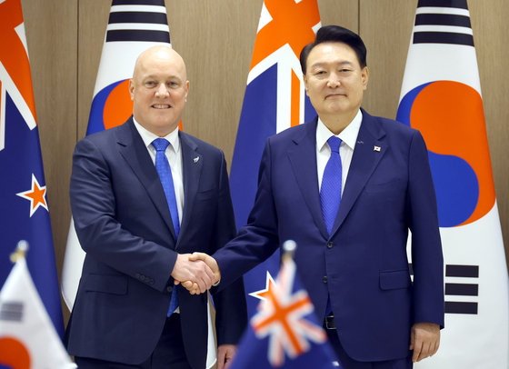 President Yoon Suk Yeol, right, and New Zealand Prime Minister Christopher Luxon pose for a photo during their summit held at the presidential office in Seoul on Wednesday. [JOINT PRESS CORPS]