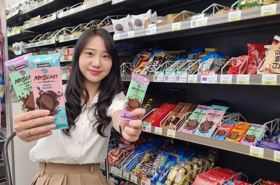 A model displays MrBeast Feastables chocolate bars that will be sold at CU stores starting Sept. 14. [BGF RETAIL]