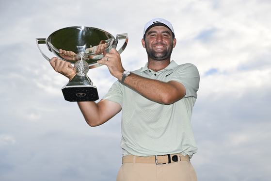 Scottie Scheffler poses for a photo with the FedExCup Trophy after winning the FedExCup and Tour Championship at East Lake Golf Club in Atlanta, Georgia on Sept. 1.  [GETTY IMAGES]