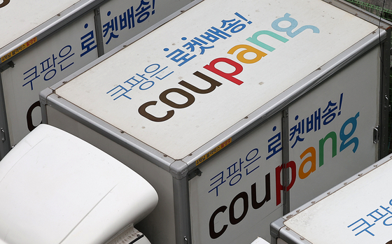 Coupang delivery trucks are parked in a parking lot in Jung District, central Seoul, in August. [NEWS1]