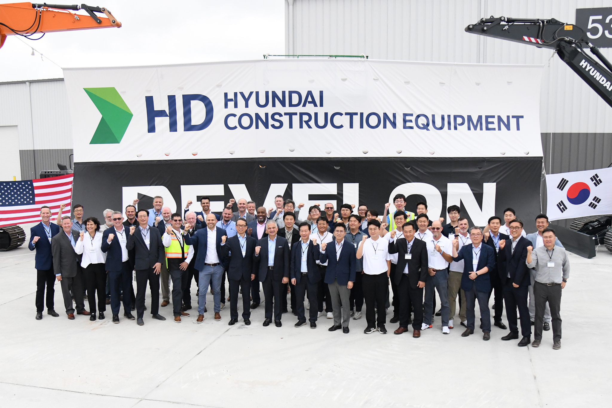 Mike Ross, senior vice president of HD Hyundai Construction Equipment North America, fourth from left in the front, poses with Moon Jae-young, chief sales officer and vice president of HD Hyundai Construction Equipment; Tommy Sidener, general manager at Wallenius Wilhelmsen; Mike Rye, senior vice president; HD Hyundai XiteSolution President Cho Young-cheul; John Felitto, chief operating officer at Wallenius Wilhelmsen; Park Chan-hyuk, vice president of HD Hyundai XiteSolution; Jeong Kwan-hee, managing director at HD Hyundai Infracore North America and other executives at the opening ceremony of an integrated customization center in Georgia on Wednesday. [HD HYUNDAI XITESOLUTION]