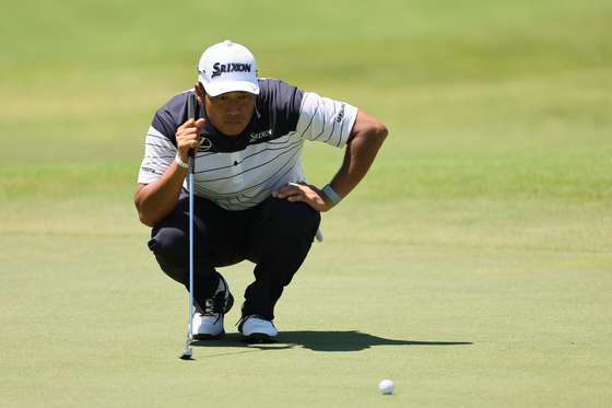 Hideki Matsuyama of Japan lines up a putt on the seventh green during the third round of the FedEx St. Jude Championship at TPC Southwind on Aug. 17 in Memphis, Tennessee. [GETTY IMAGES]