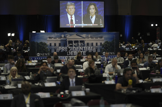 A presidential debate between Republican presidential nominee former President Donald Trump, on screen on the left, and Democratic presidential nominee Vice President Kamala Harris is seen from the spin room on Tuesday in Philadelphia. (AP Photo/Matt Rourke)