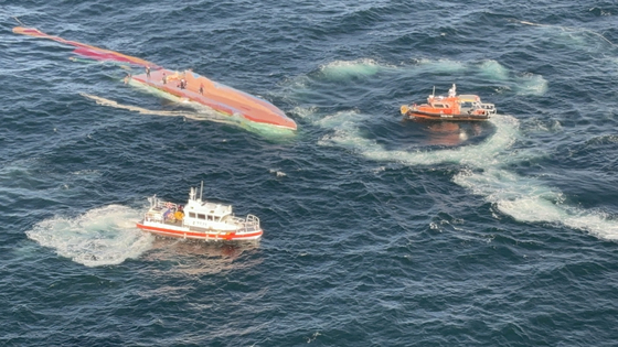 The Coast Guard conducts rescue operations after a 35-ton fishing vessel capsizes in waters near Gunsan, North Jeolla, on Monday. [YONHAP] 