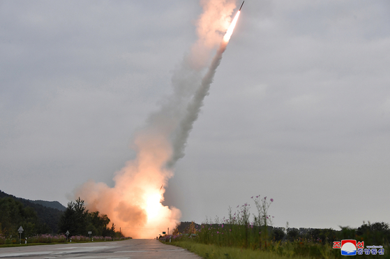 North Korean leader Kim Jong-un inspects a test-firing of a new 600-millimenter multiple rocket launcher, in a photo provided by the North's official Korean Central News Agency on Friday. [YONHAP]