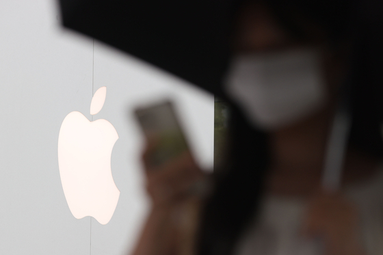 A pedestrian passes by an Apple Store in Seoul on Thursday. [YONHAP]