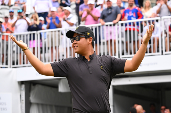 International Team Member Tom Kim asks the crowd for more noise as he arrives on the first tee during the final round singles matches of Presidents Cup at Quail Hollow Sept. 25, 2022, in Charlotte, North Carolina. [GETTY IMAGES]