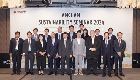 James Kim, center in the front row, the chairman and CEO of the American Chamber of Commerce in Korea (Amcham), and speakers and panelists at the Amcham Sustainability Seminar 2024 take a group photo at the Four Seasons Hotel in central Seoul on Thursday. [AMCHAM]