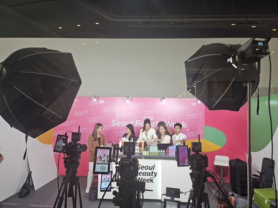 Thai influencers arrange Korean cosmetic products for a live commerce session at a studio during Seoul Beauty Week 2024 at Dongdaemun Design Plaza (DDP) in Jung District, central Seoul, on Tuesday. [SEOUL METROPOLITAN GOVERNMENT]