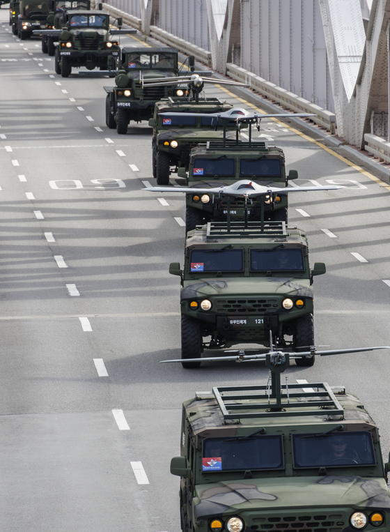 Unmanned combat aerial vehicles cross the Hangang Bridge to take part in a military parade in downtown Seoul Tuesday. [YONHAP]