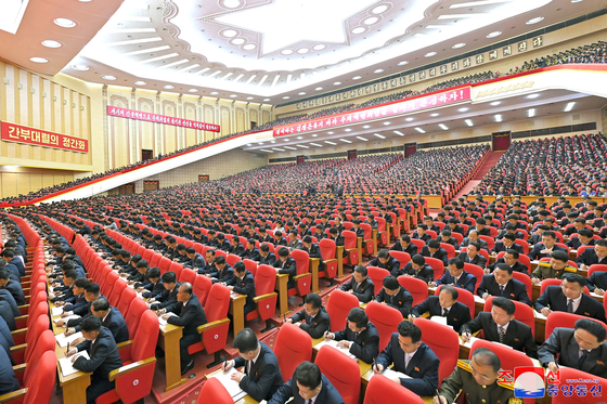 Participants of North Korea's first national cadres in Pyongyang sign papers, in a photo released by the North's official Korean Central News Agency on Wednesday. [YONHAP]