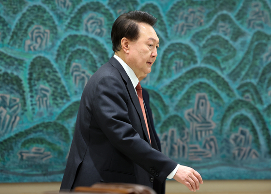 President Yoon Suk Yeol walks into a meeting room at the presidential office in Yongsan District, central Seoul, on Wednesday. [YONHAP]