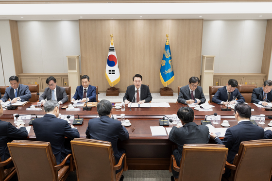 President Yoon Suk Yeol, center, presides over an emergency meeting reviewing the economic and security risks of the Middle East crisis at the Yongsan presidential office in centrla Seoul on Wednesday. [JOINT PRESS CORPS] 