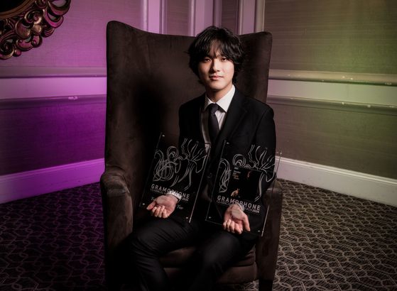 Pianist Yunchan Lim poses with his two awards for the Gramophone Classical Music Awards in the piano and Young Artist of the Year categories after the ceremony in London on Wednesday. [GRAMOPHONE]