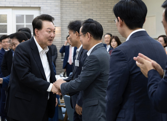 President Yoon Suk Yeol, far left, greets high-ranking People Power Party lawmakers at the presidential office in Yongsan District, central Seoul, on Wednesday. [PRESIDENTIAL OFFICE]