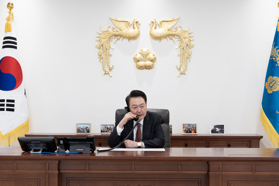 President Yoon Suk Yeol talks on the phone with Japan's new Prime Minister Shigeru Ishiba at his office in Seoul on Wednesday. [PRESIDENTIAL OFFICE]