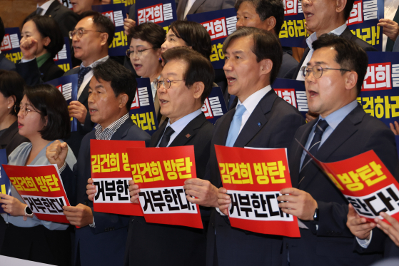 Democratic Party leader Lee Jae-myung, third from left, and Rebuilding Korea Party leader Cho Kuk, second from right, hold up placards during a protest by liberal lawmakers against President Yoon Suk Yeol's veto of a special counsel bill to probe various allegations against first lady Kim Keon Hee. The bill was scrapped on Friday in the face of opposition from the conservative People Power Party, which is aligned with the government. [YONHAP]