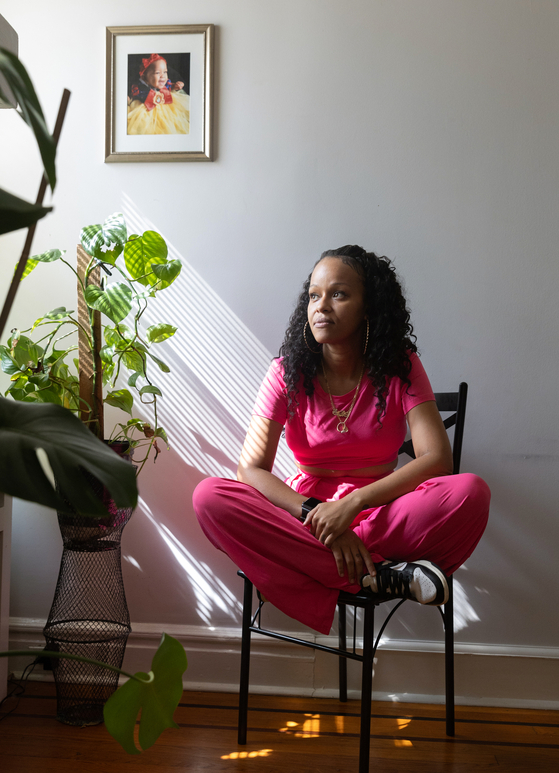 Jeanelle Adams, 36, in her home in Newark, N.J., on Sept. 30, 2024. It took Adams, who has triple-negative breast cancer, two years to get the correct diagnosis and as death rates decline, the disease is turning up more often in women under age 50. (Jackie Molloy/The New York Times)