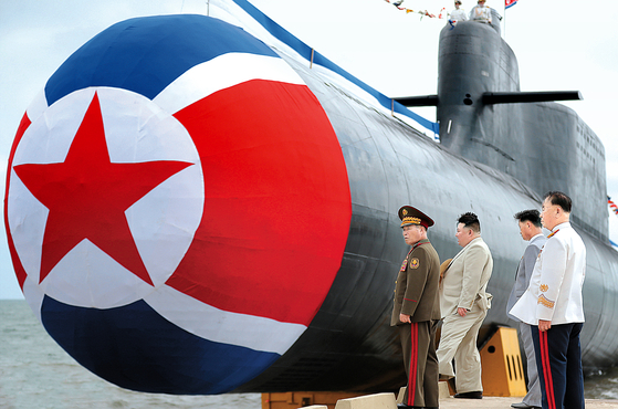 North Korean leader Kim Jong-un, second from left, attends a ceremony to launch a newly built ″tactical nuclear attack submarine” on Sept. 6, 2023, in a photo released by the country's official Korean Central News Agency two days later. [YONHAP]